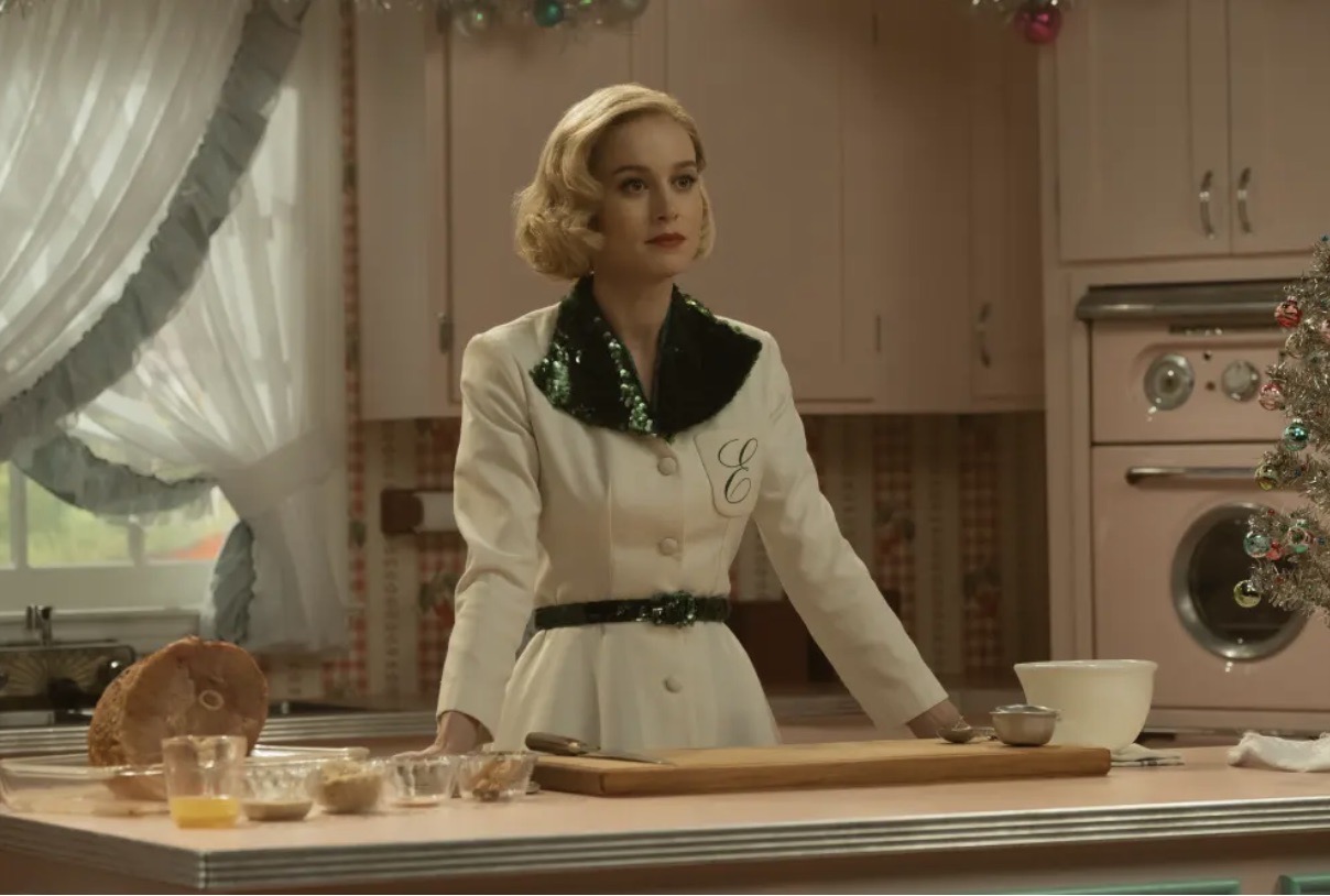 Brie Larson in a belted 1950s dress in a pastel kitchen, Lessons in Chemistry